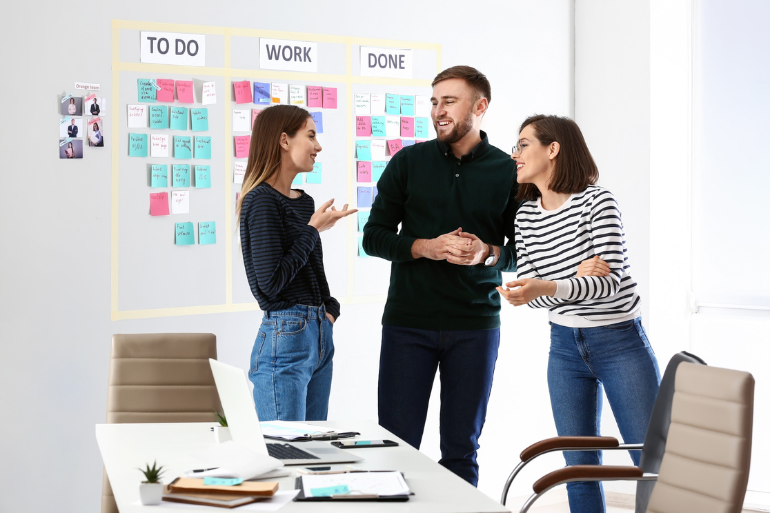 Young Business People near Scrum Task Board in Office